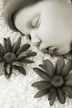 Beautiful newborn baby girl sleeping on a fluffy blanket