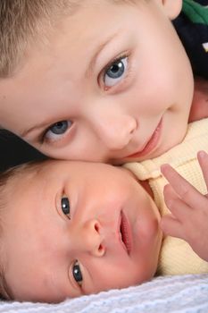 Blond boy with his newborn baby brother