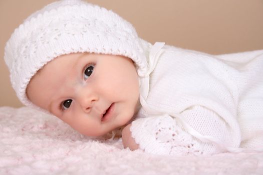 Beautiful two month old baby girl wearing a knitted outfit 