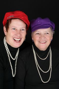 Adult mother and daughter wearing red and purple hats 