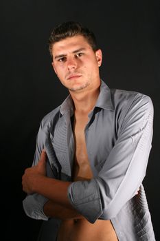 Male model in studio against a dark wall