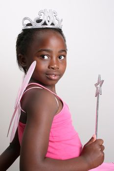 Young girl wearing a pink fairy costume with accessories