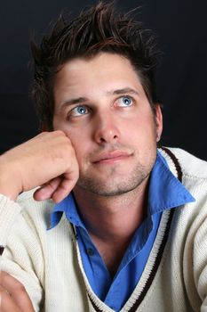 Male model in studio against black background