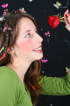 Teenage model with flowers and butterflies in her hair