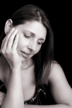 Beautiful brunette female model against a dark background