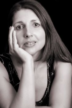 Beautiful brunette female model against a dark background