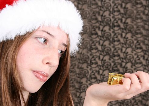 Brunette Teenager wearing a fluffy christmas hat