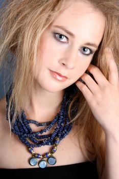 Beautiful female model with blue eyes wearing jewelery