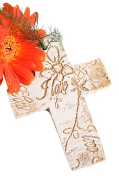 Decorative cross with wording on and an orange flower