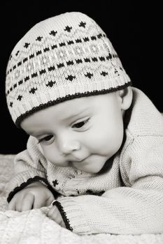 Cute four month old baby boy lying on his tummy
