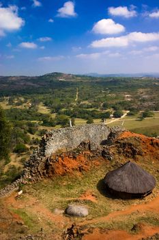 A view of a thatched hut and the protective wall from the king''s enclosure at Great Zimbawe.