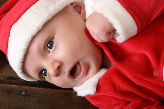 Cute 6 week old baby boy wearing a christmas suit