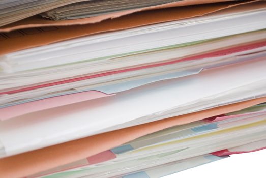 Pile of cardboard folders filled with papers and dividers- colours: blue, orange and pink.  Divider labels are blank and could have text added if desired.