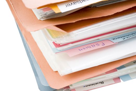 An untidy pile of folders, filled with papers, containing labelled dividers - the most legible divider is labelled 'Pension'.  Folders are made of cardboard and coloured orange and blue.
