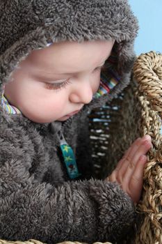 Four month old baby boy wearing a fully bear suit