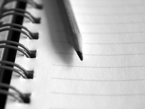 Blank notebook page with pencil on top
