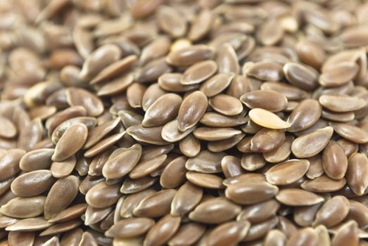 Closeup of a pile of linseeds (aka flaxseeds) filling whole frame.