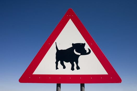 Close up of a warning sign for warthogs on the roadside in Namibia