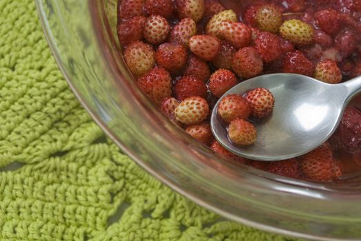 Portion of sweet strawberry jam. The spoon is applied