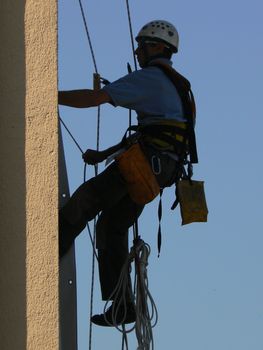 man suspended and sky blue and white