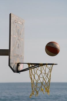 action shot of a basketball just about to go through the hoop