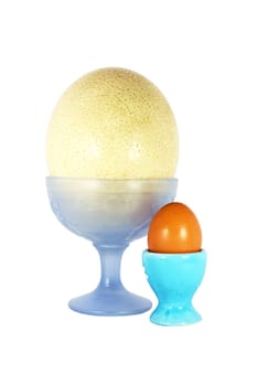 One big and one small egg on the pedestal isolated on the white