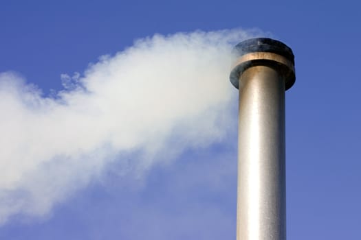 a chimney with white smoke coming out of it with a blue sky background