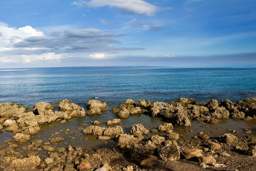 It is a beautiful coral reef rock coastline with blue sky in kenting of Taiwan.