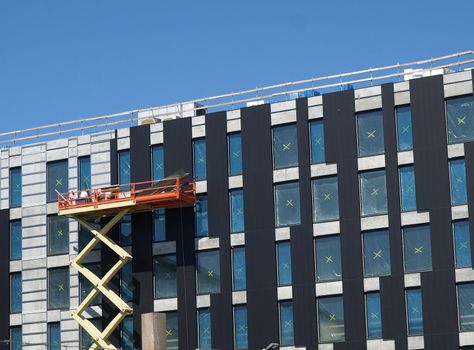 industrial scissor lift in use for building construction