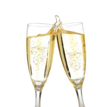 Pair of champagne flutes making a toast. Champagne splash