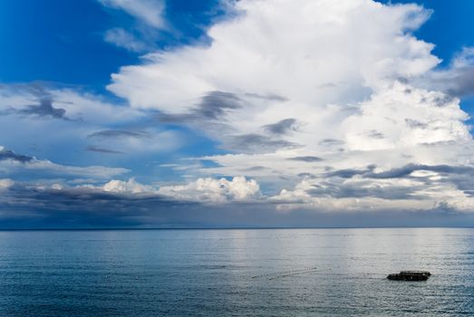 It is beautiful sky and ocean with fishing boats.