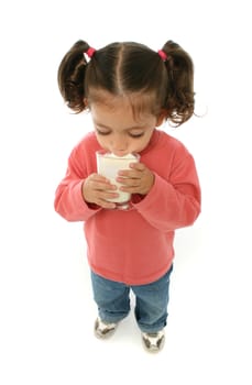 Toddler enjoying a glass of fresh milk