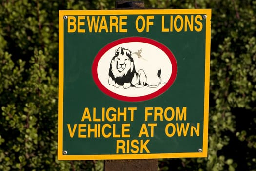 Sign in southern african game park warning of the dangers of leaving your vehicle