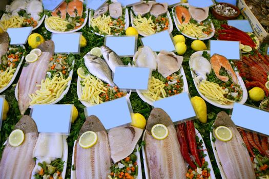 Prepared raw seafood fish plates on Mediterranean market