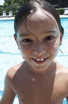 Little boy playing at pool