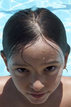 Little boy playing at pool