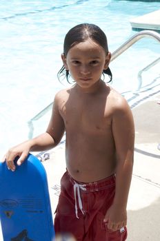 Little boy playing at pool