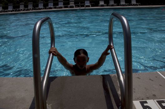 Little boy playing at pool