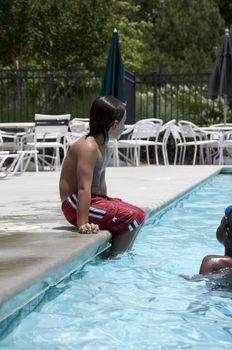 Little boy playing at pool