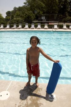 Little boy playing at pool