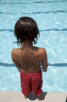 Little boy playing at pool