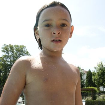 Little boy playing at pool