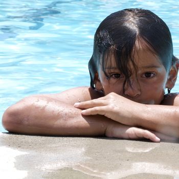 Little boy playing at pool