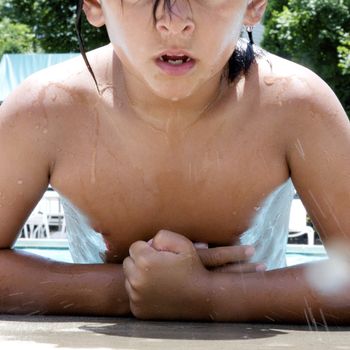 Little boy playing at pool