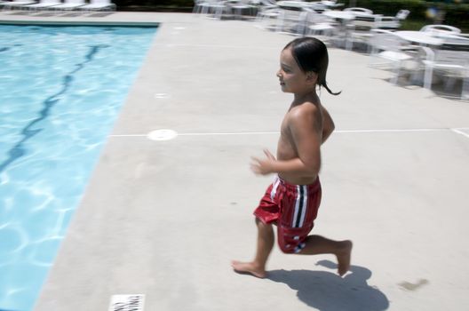 Little boy jumping into pool