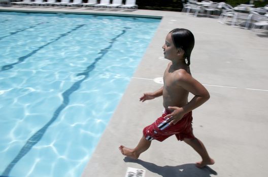Little boy jumping into pool