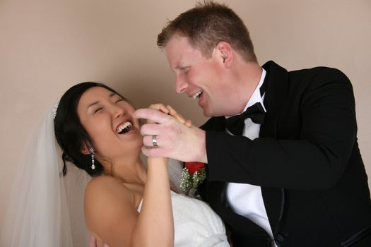 Laughing bride and groom as he dips her