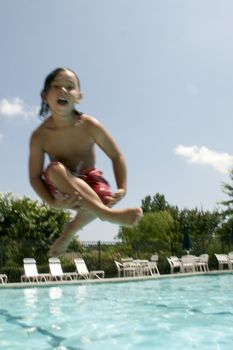 Little boy jumping into pool