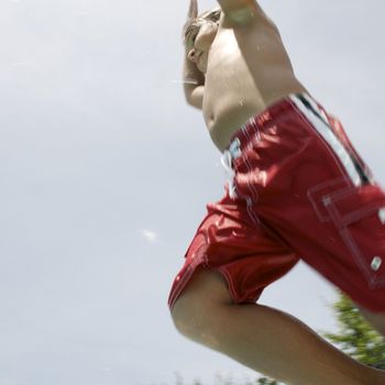 Little boy jumping into pool