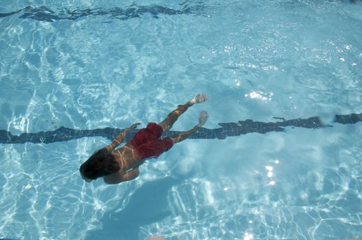 Little boy learning to swim